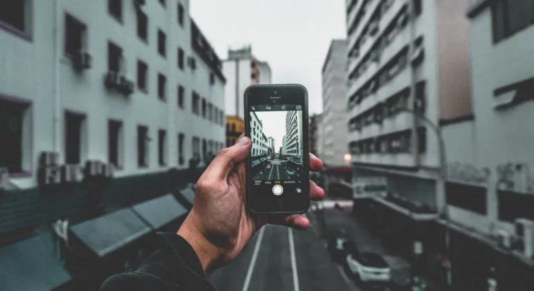 Man taking a picture of the street with his smartphone