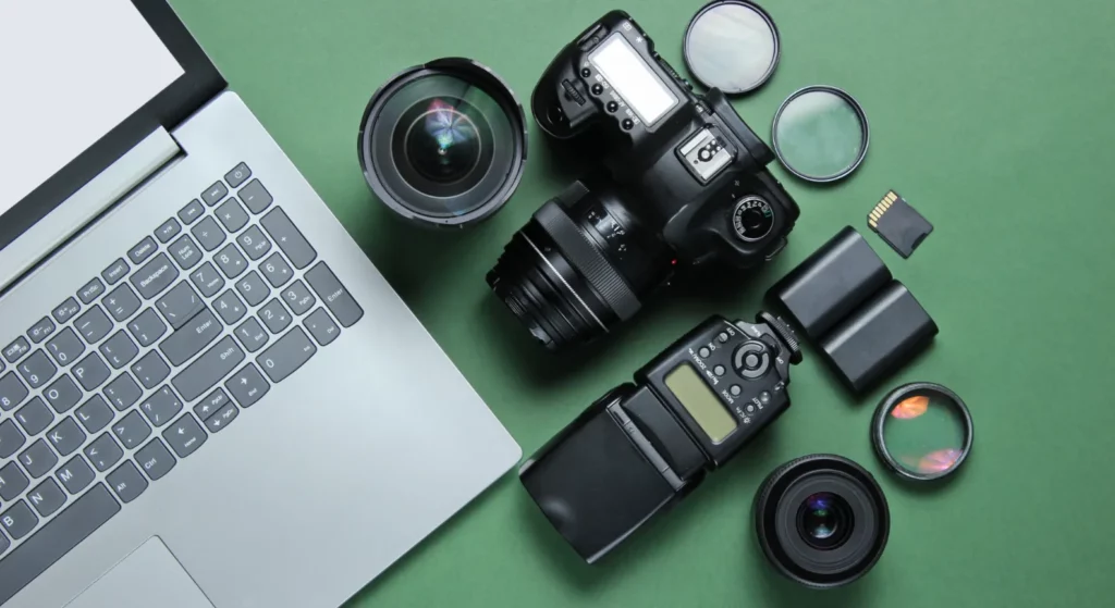 Camera equipment next to laptop
